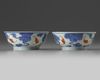 A pair of Chinese iron-red and gilt decorated blue and white bowls and cover