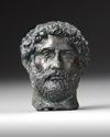 A MINIATURE BRONZE HEAD OF THE EMPEROR HADRIAN, 117-138 AD 2ND CENTURY AD