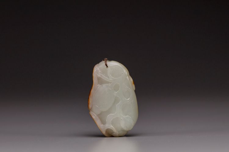 A white and russet jade 'melon' pendant