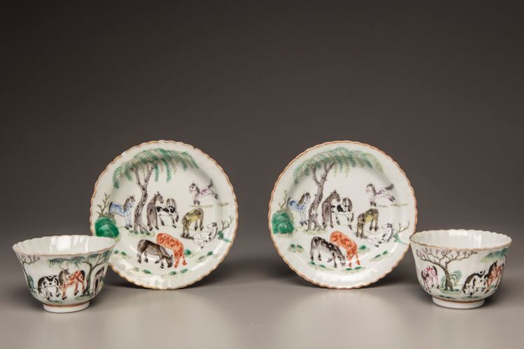 Two pairs of famille rose 'Eight Horses of Mu Wang' foliate cups and saucers