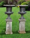 A PAIR OF CAST IRON CAMPANA URNS, 19TH CENTURY