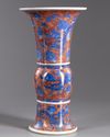 A Chinese iron-red-ground blue and white 'dragon and lotus' vase, gu
