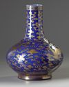 A Chinese blue-ground gilt-decorated 'dragon and phoenix' bottle vase