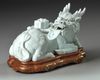 A CHINESE WHITE GLAZED SEATED DRAGON, QING DYNASTY (1644–1911)