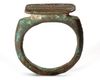 AN ISLAMIC KUFIC INSCRIBED BRONZE RING