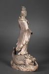 A METAL SCULPTURE OF GUANYIN STANDING ON A FISH, 20TH CENTURY