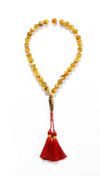AN AMBER-COLORED TASBIH (MISBAHA)