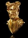 A ROMAN REPOUSSÉ GOLD BUST OF A MAN WITH WINGED HEAD, CIRCA 2ND CENTURY A.D.