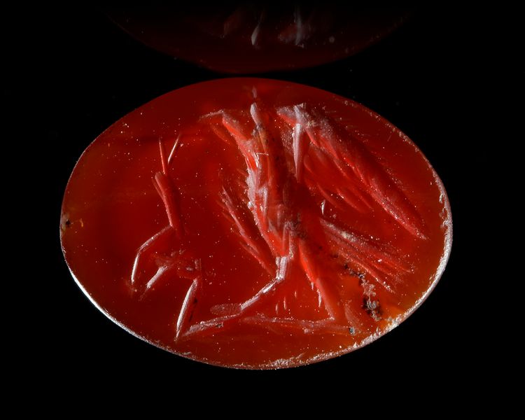 A ROMAN INTAGLIO IN CARNELIAN OF AN EAGLE FIGHTING A SNAKE, 2ND CENTURY AD