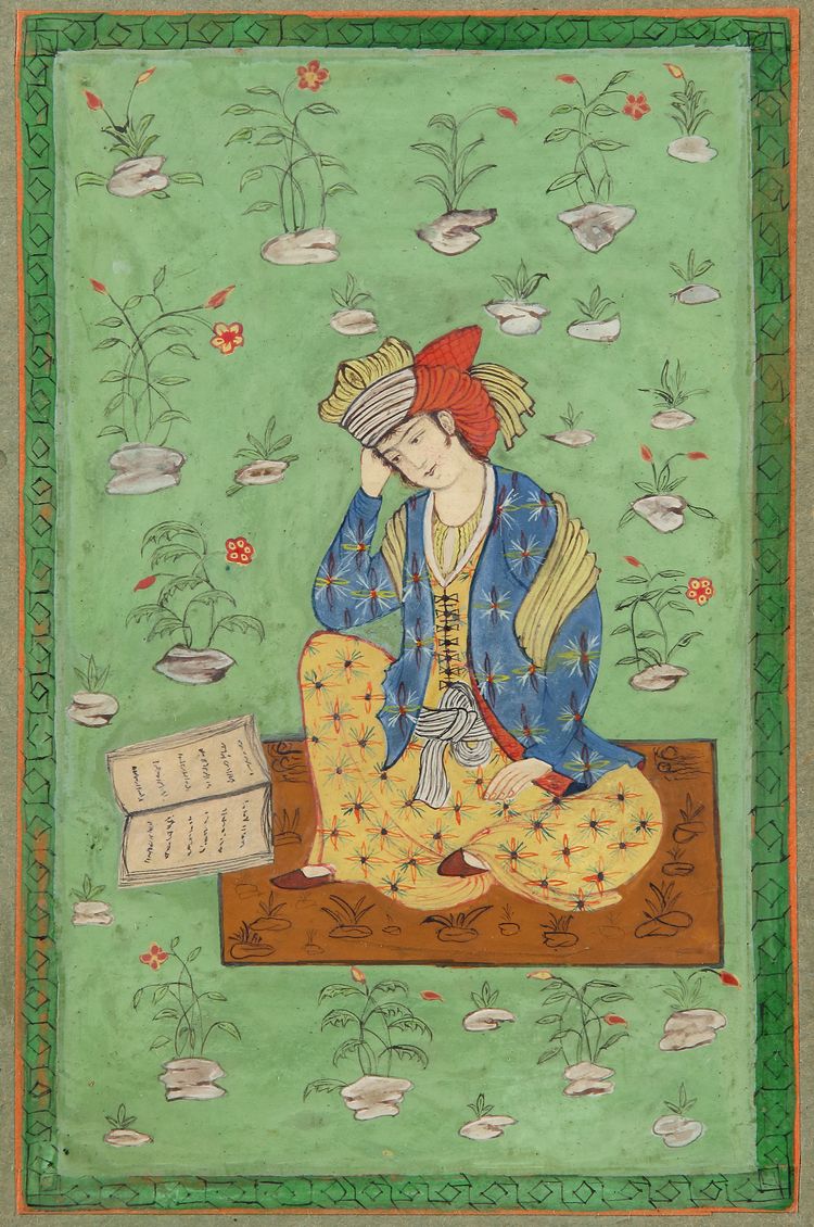 A seated young man with a book