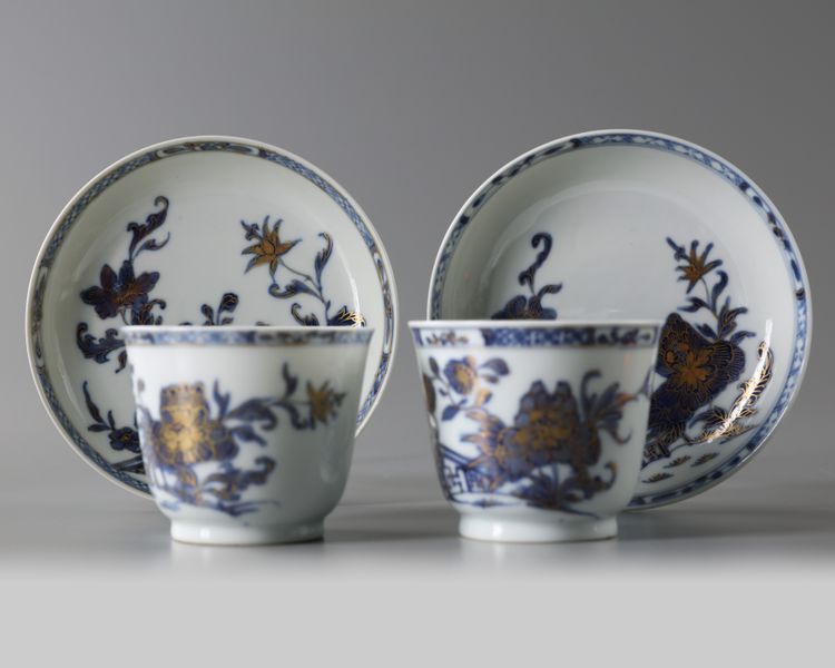 A PAIR OF CHINESE BLUE AND WHITE 'PEONY' CUPS AND SAUCERS, 18TH CENTURY