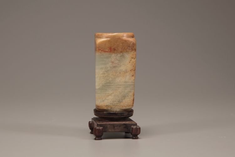 A pale celadon and russet jade cong