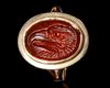 A CARNELIAN ROMAN INTAGLIO OF AN EAGLE'S HEAD, 1ST CENTURY AD