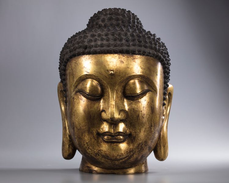 A large Chinese gilt bronze buddha head