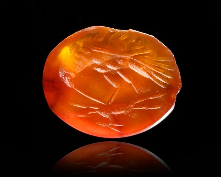 A CARNELIAN INTAGLIO OF AN EAGLE WITH A GAZELLE, 2ND CENTURY AD