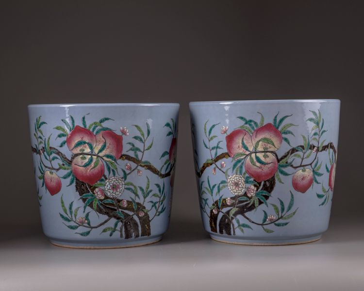 A pair of Chinese blue-ground famille rose 'nine peach' jardinieres
