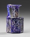A COBALT BLUE MOLDED GLASS JUGLET, EASTERN MEDITERRANEAN, 1ST–3RD CENTURY AD