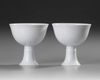 A PAIR OF CHINESE WHITE-GLAZED DRAGONS STEM CUPS, 20TH CENTURY