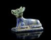 A LAPIS LAZULI RECUMBENT JACKAL, LATE PTOLEMAIC-ROMAN PERIOD, CIRCA 200 BC-100 AD