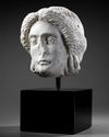 A MARBLE HEAD OF APOLLO, ROMAN 1ST CENTURY AD