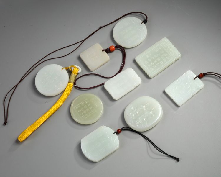 A group of nine Chinese white and pale celadon jade plaques