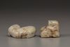 A creamy jade water buffalo and a celadon and russet jade Buddhist lion