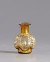 A ROMAN HEAD GLASS FLASK, CIRCA 3RD CENTURY AD