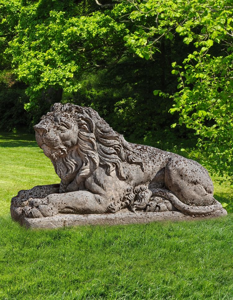 A SCULPTED LIMESTONE MODEL OF A RECUMBENT LION, SECOND HALF 20TH CENTURY
