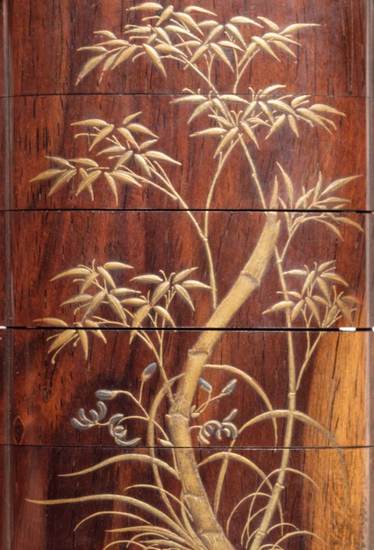 A five part inrō-case decorated with a floral design and (reverse) bamboo