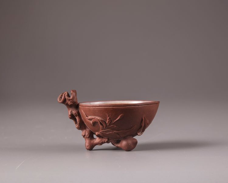 A Chinese yixing peach-form coupe and a yixing floral palette