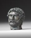 A MINIATURE BRONZE HEAD OF THE EMPEROR HADRIAN, 117-138 AD 2ND CENTURY AD