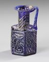A COBALT BLUE MOLDED GLASS JUGLET, EASTERN MEDITERRANEAN, 1ST–3RD CENTURY AD