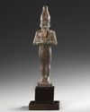 AN EGYPTIAN BRONZE OSIRIS STATUE, 26TH DYNASTY, CIRCA 664–525 B.C.