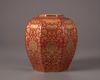 A coral-red ground gilt floral-decorated jar