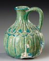 A TURQUOISE BLUE GLAZED POTTERY JUG, PERSIA, 10TH-11TH CENTURY