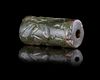 A GREEN CHALCEDONY CYLINDER SEAL, CIRCA 8TH-7TH CENTURY BC