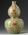 A Chinese lime green ground iron red decorated double gourd vase