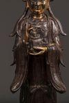 A Chinese parcel-gilt bronze figure of Xiwangmu