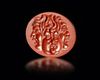 A RED JASPER INTAGLIO WITH A GRYLLOS WITH FOUR HEADS, ROMAN 1ST CENTURY AD