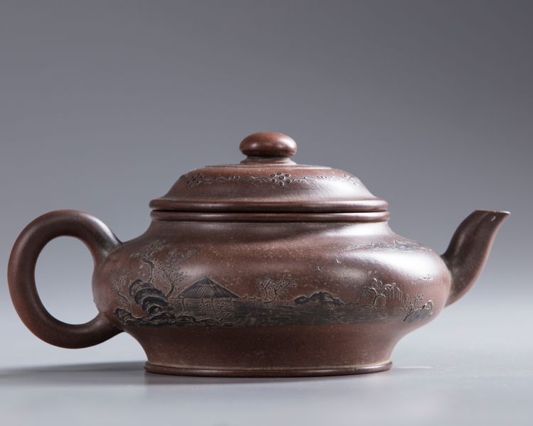 A Chinese Yixing 'landscape' teapot and cover