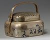 A Chinese brass 'narrative' hand warmer