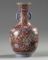A Chinese red-ground famille rose bottle vase