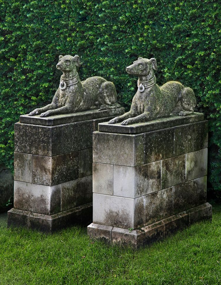 A PAIR OF SCULPTED LIMESTONE MODELS OF RECUMBENT HOUNDS, SECOND HALF 20TH CENTURY