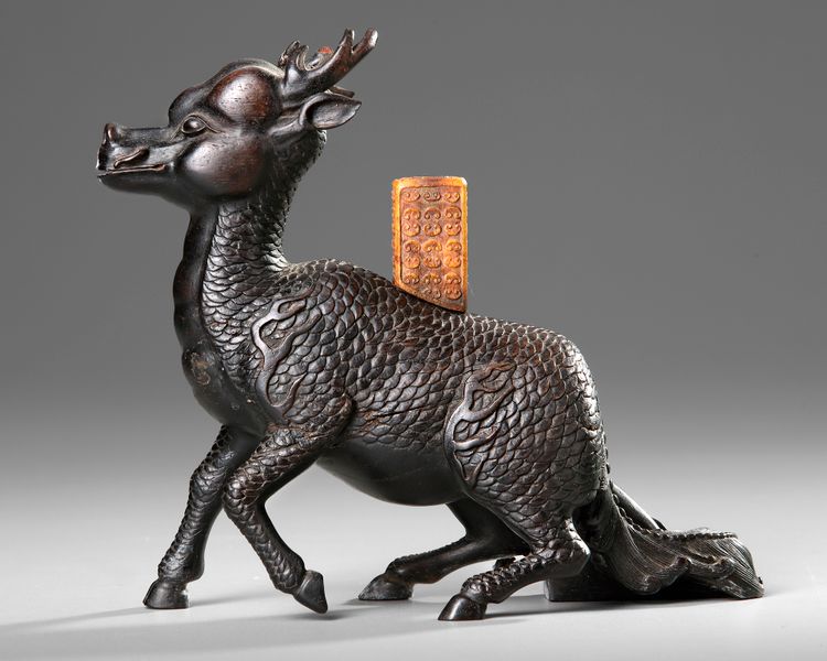 A ZITAN INCENSE STICK HOLDER OF A QILIN      18TH/19TH CENTURY
