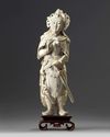 A large Chinese carved ivory figure of a guardian