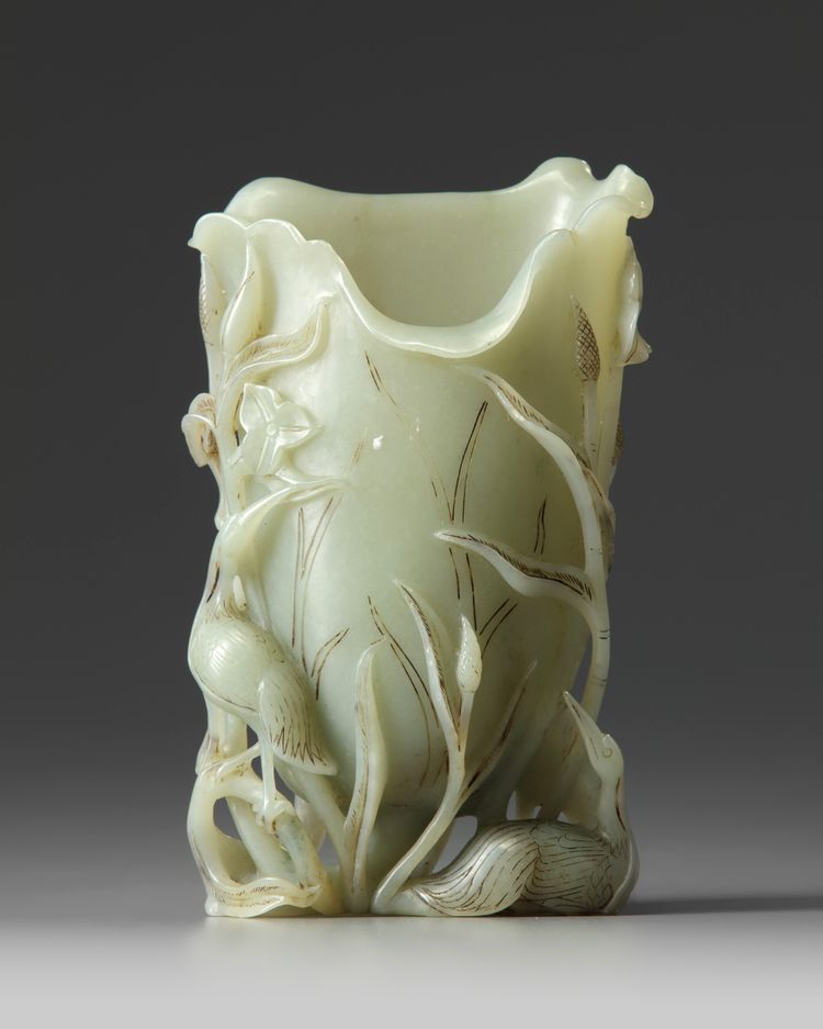 A Chinese celadon jade ‘crane and lotus’ spill vase