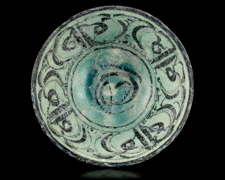 A KASHAN TURQUOISE AND BLACK POTTERY BOWL, PERSIA, 12TH-13TH CENTURY