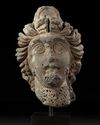 A ROMAN BASALT HEAD OF A WOMAN "HAURAN", CIRCA 2ND CENTURY A.D.