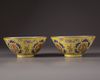 A pair of Chinese yellow-ground famille rose bowls
