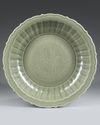 A LARGE LONGQUAN CELADON BARBED-RIM DISH
